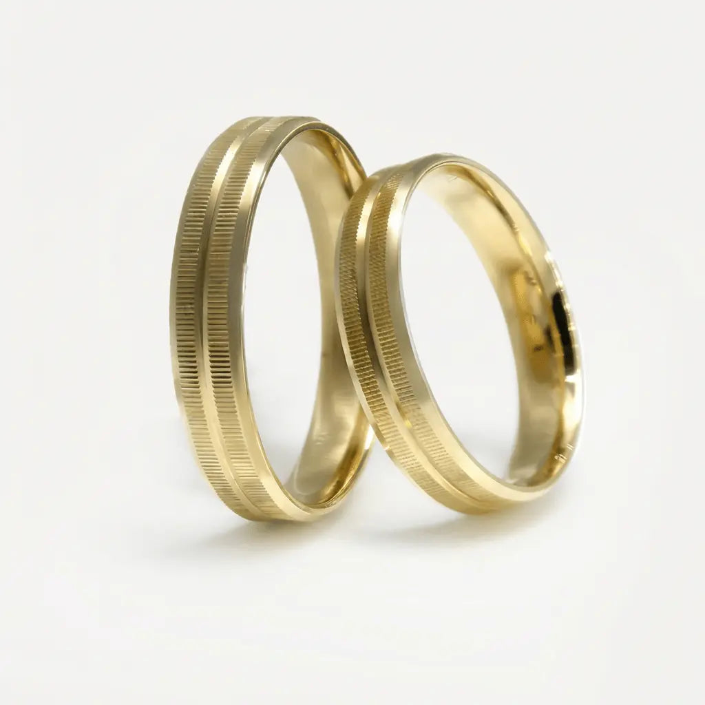 A gold wedding band with a linear texture, 4mm wide, shown in 9ct gold, part of the Aurelia line by Majestic Jewellery.