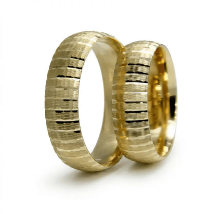 A 6mm gold wedding band with layered texture strata in 9ct gold, shown against a soft background by Majestic Jewellery.