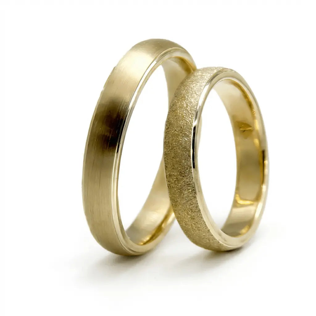 A 4mm gold wedding band with minimal texture and satin dust finish in 9ct gold, shown against a neutral background by Majesti