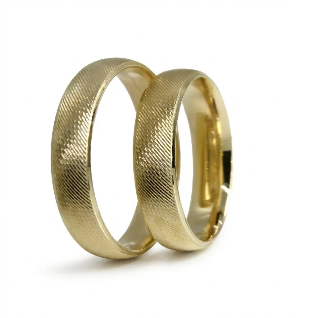 A brushed 5mm gold wedding band in 9ct gold, shown against a black background with a subtle texture for contrast by Majestic 