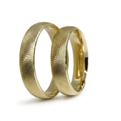 A brushed 5mm gold wedding band in 9ct gold, shown against a black background with a subtle texture for contrast by Majestic 