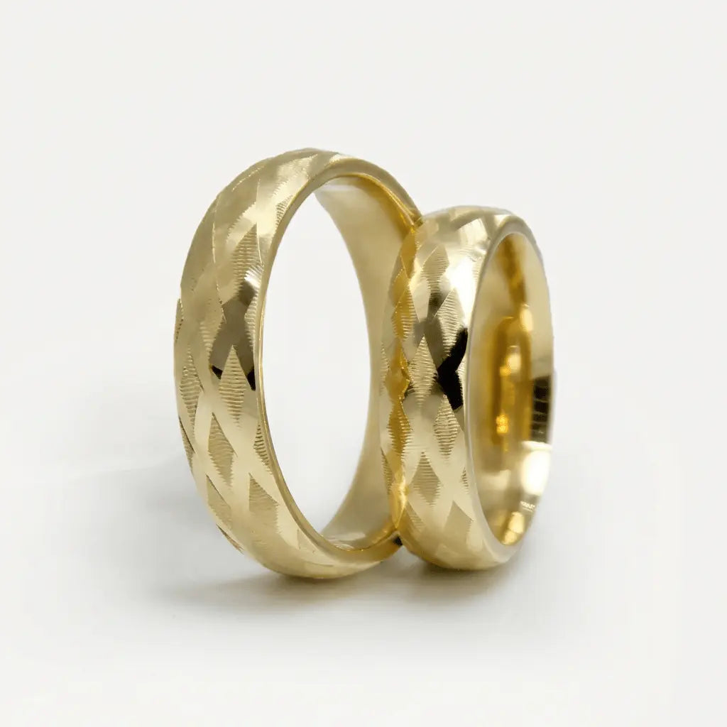 A 5mm gold wedding band with cross faceted design in 9ct gold, shown against a soft background by Majestic Jewellery.