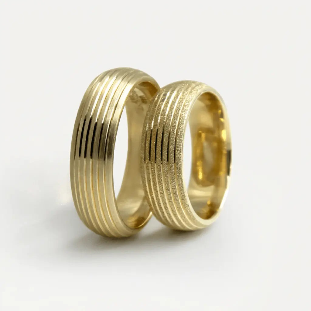A 6mm gold wedding band with parallel line satin finish in 9ct gold, shown against a soft background by Majestic Jewellery.