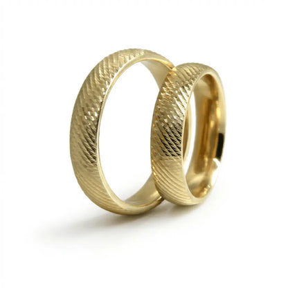 A 5mm gold wedding band with a diagonal weave texture in 9ct gold, shown against a soft background by Majestic Jewellery.