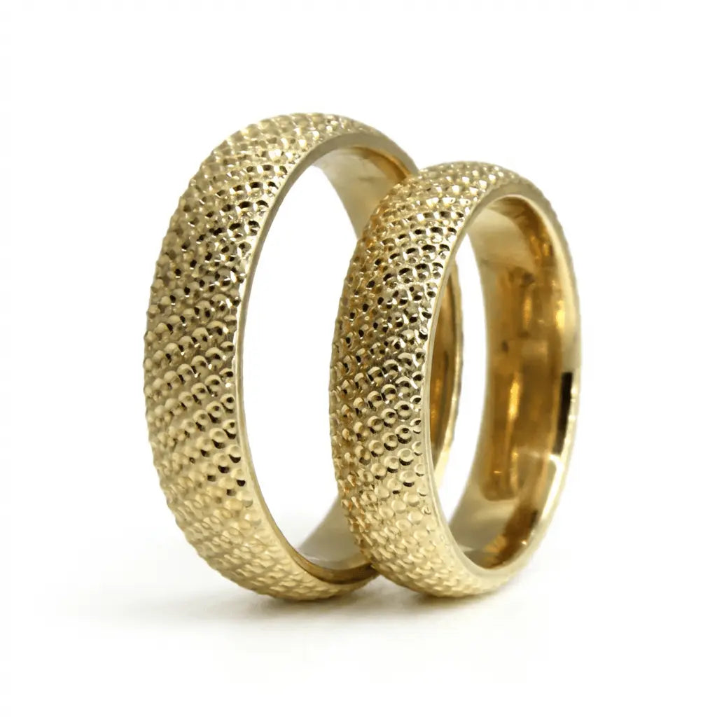 A 5mm gold wedding band with a granulated texture in 9ct gold, shown as a close-up of the ring's surface by Majestic Jeweller
