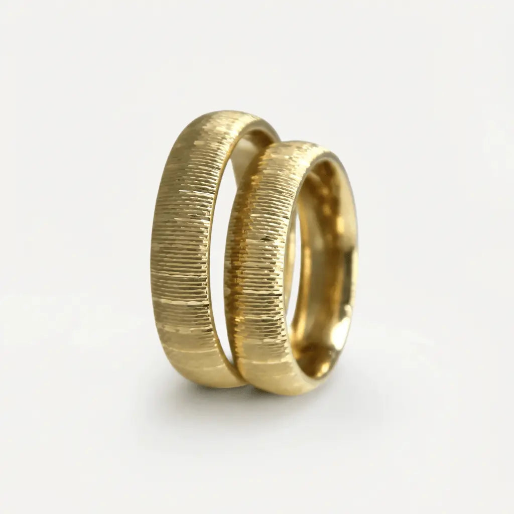A 5mm gold wedding band with vertical ribbed texture in 9ct gold, shown against a neutral background by Majestic Jewellery.