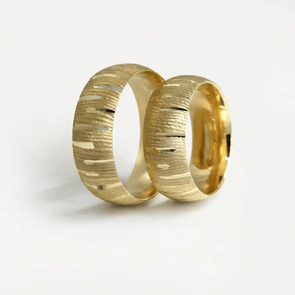 A 7mm gold wedding band with horizontal texture in 9ct gold, shown against a black background by Majestic Jewellery.