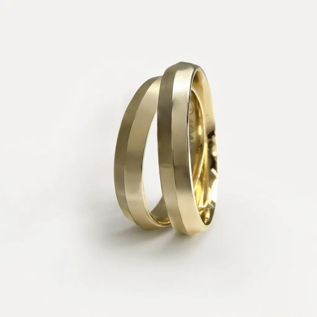 A 4mm gold wedding band in elegant width displayed on a white background, showing the polished 9ct, 14ct, and 18ct gold finis