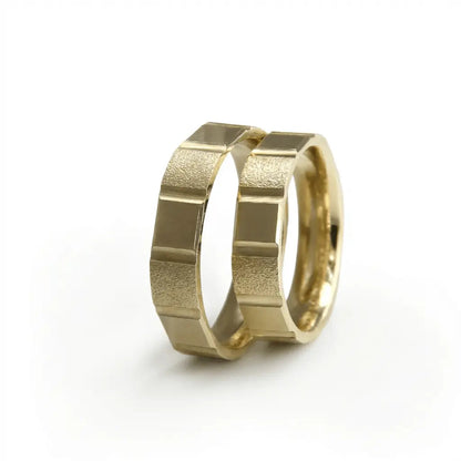 A 5mm gold wedding band with a segmented block texture in 14ct gold, displayed on a white background by Majestic Jewellery.
