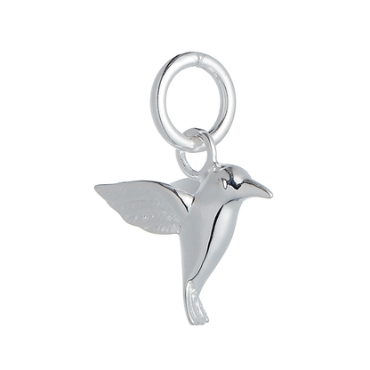 A silver hummingbird charm shaped like a delicate winged bird, displayed on a soft white background by Scarlett Jewellery.