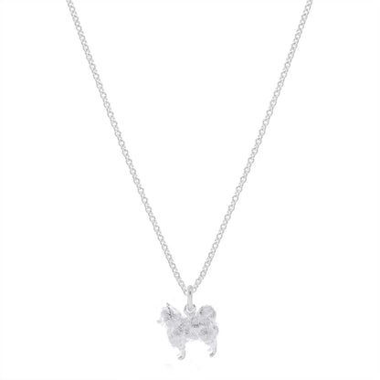 A silver Pomeranian dog charm shaped like a small paw print, detailed with delicate engravings, by Scarlett Jewellery.