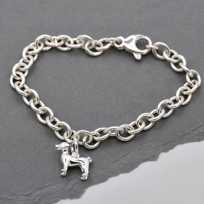 Silver Jack Russell Terrier dog charm by Scarlett Jewellery displayed on a soft fabric background.