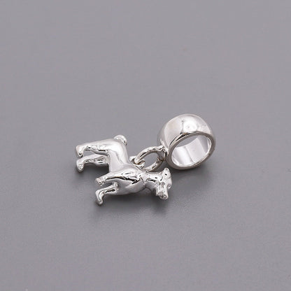 Silver Jack Russell Terrier dog charm by Scarlett Jewellery displayed on a soft fabric background.
