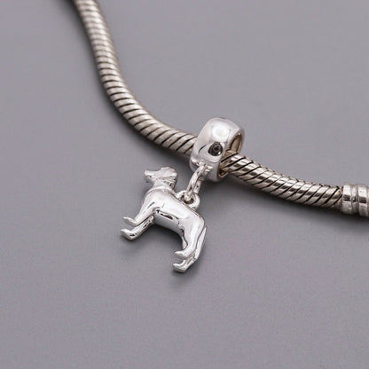 A silver Labrador dog charm shaped like a loyal companion, displayed on a soft background, by Scarlett Jewellery.
