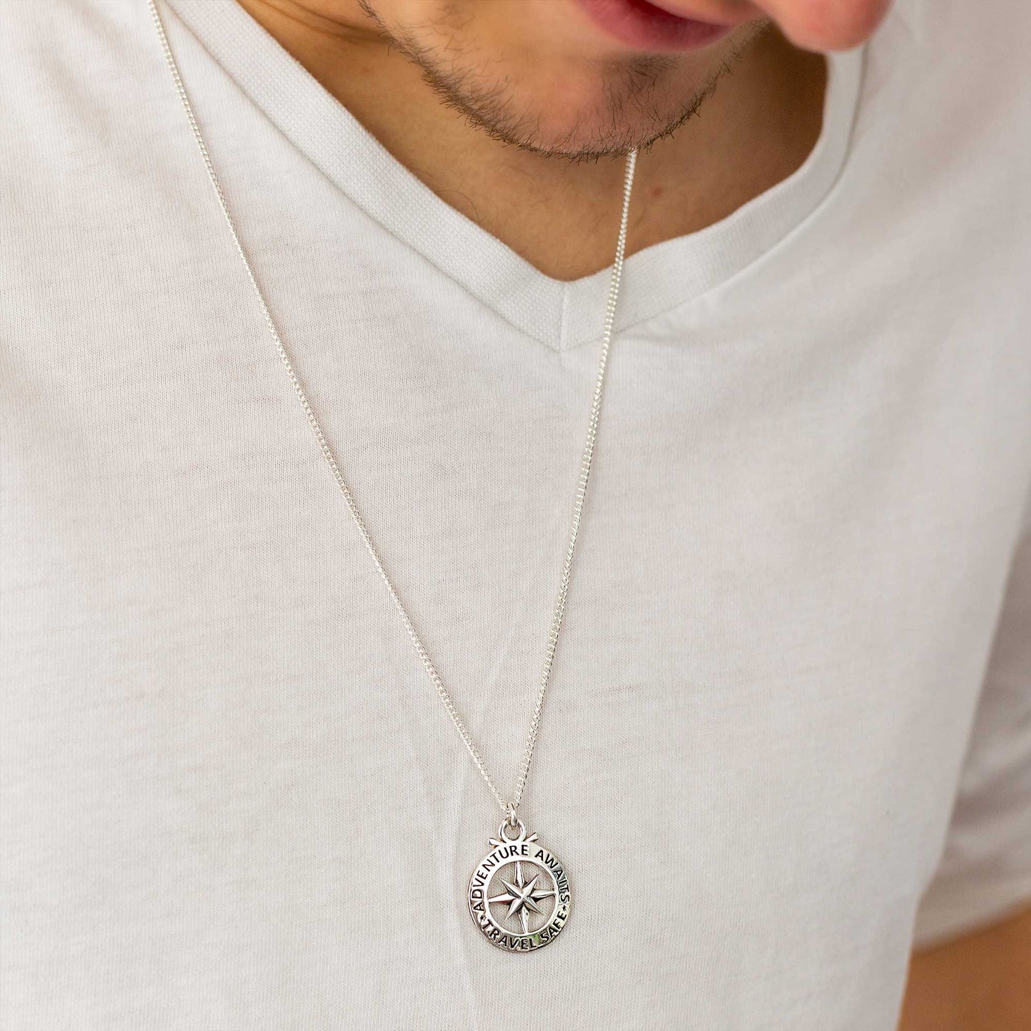 Large silver necklace featuring an outline compass and St Christopher icon by Scarlett Jewellery.
