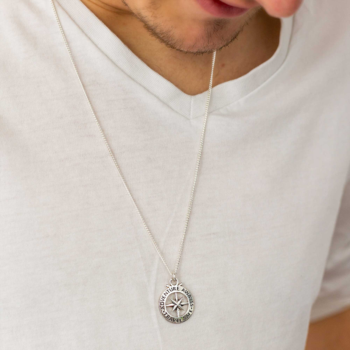 Large silver necklace featuring an outline compass and St Christopher icon by Scarlett Jewellery.