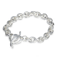 A silver charm bracelet with a heart-shaped charm, detailed engravings, and a polished finish by Scarlett Jewellery.