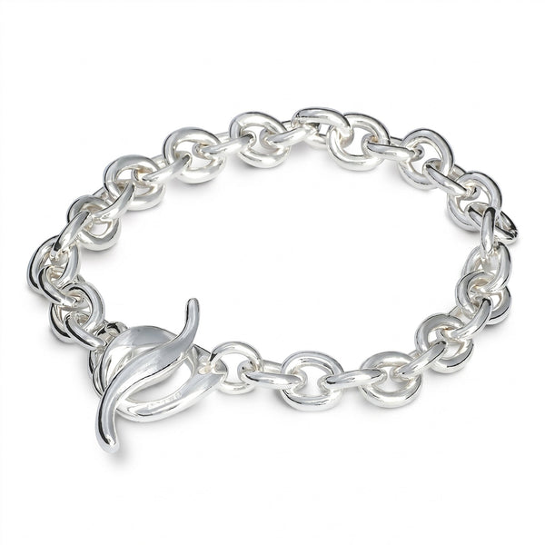 A silver charm bracelet with a heart-shaped charm, detailed engravings, and a polished finish by Scarlett Jewellery.