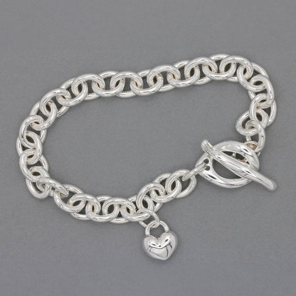 Silver heart charm bracelet with delicate chain and engraved details by Scarlett Jewellery.
