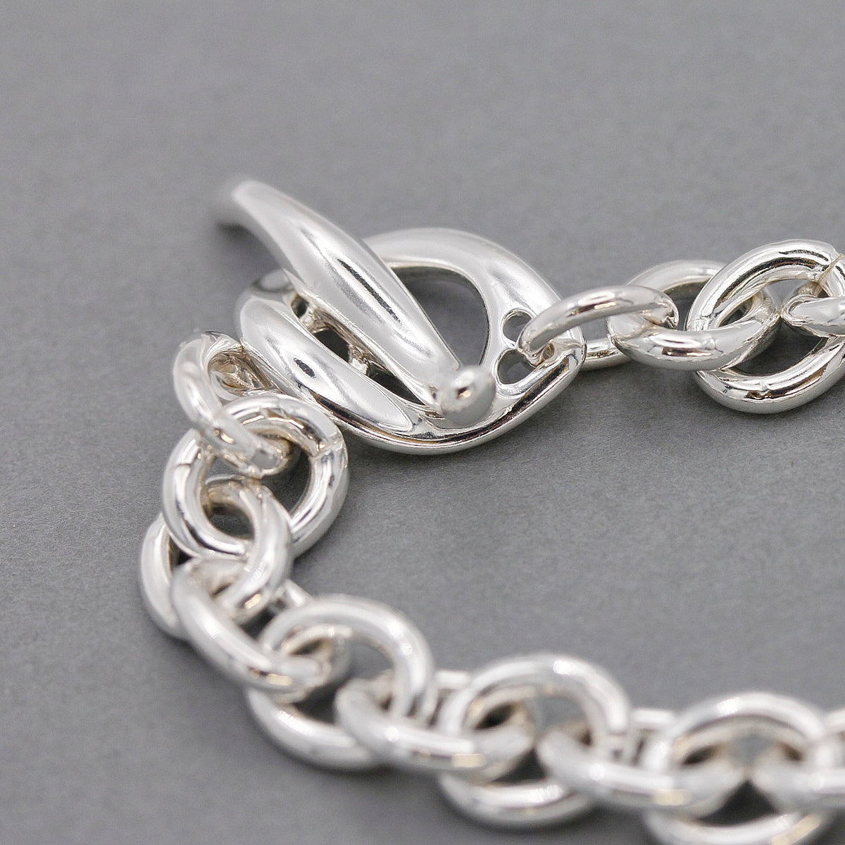 Silver charm bracelet with delicate pendant and adjustable clasp by Scarlett Jewellery.