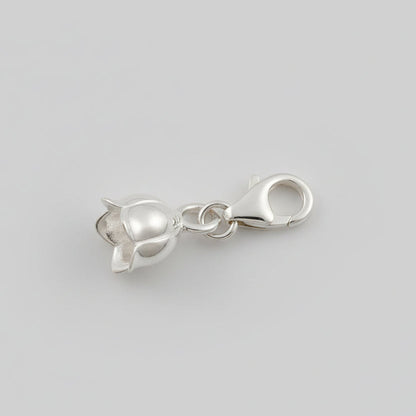 A silver lily of the valley flower charm with delicate detailing, displayed on a soft white background by Scarlett Jewellery.