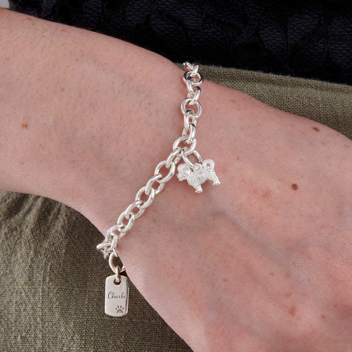 Silver dog charm bracelet featuring a Maltipoo design by Scarlett Jewellery.