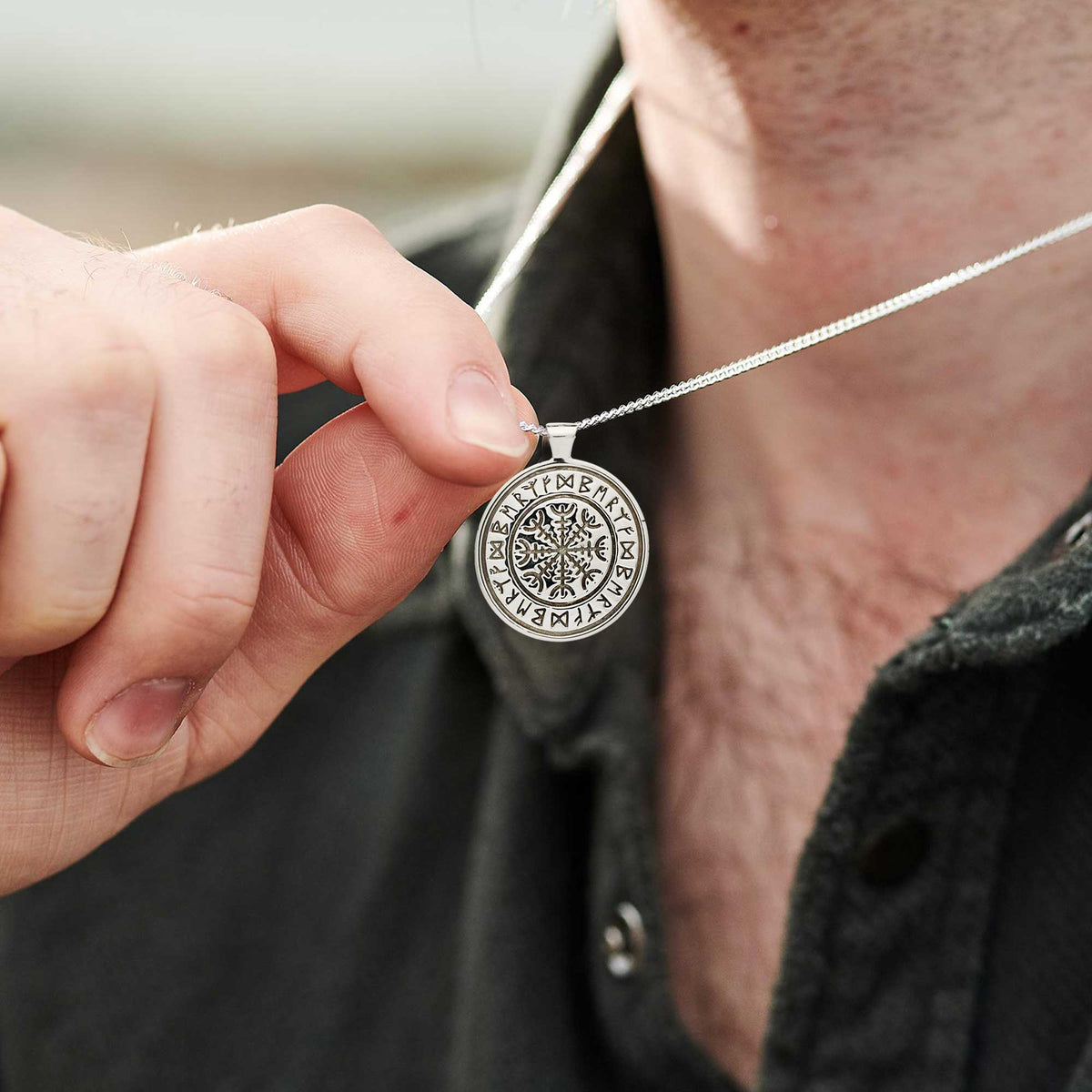 Silver Viking rune necklace with personalized engraving, shown close-up against a dark background by Scarlett Jewellery.