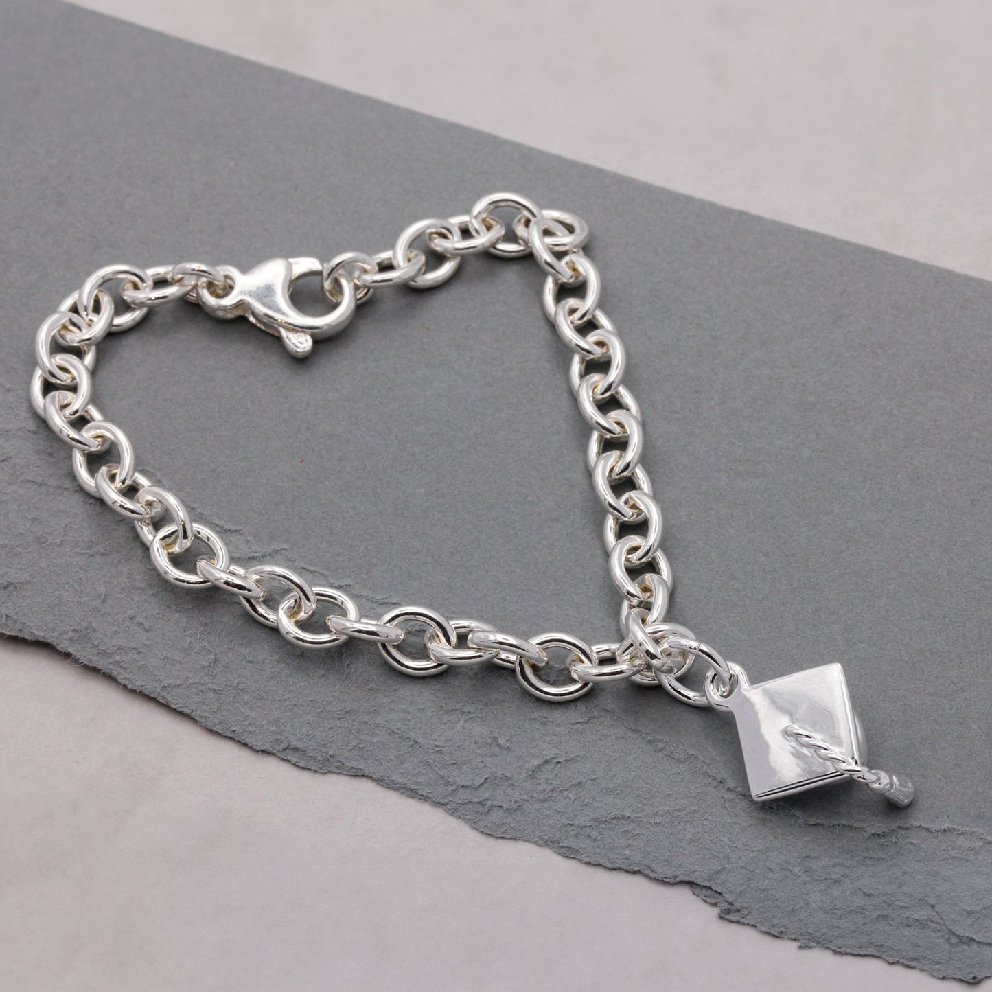 Silver charm bracelet with personalized mortar board charm by Scarlett Jewellery