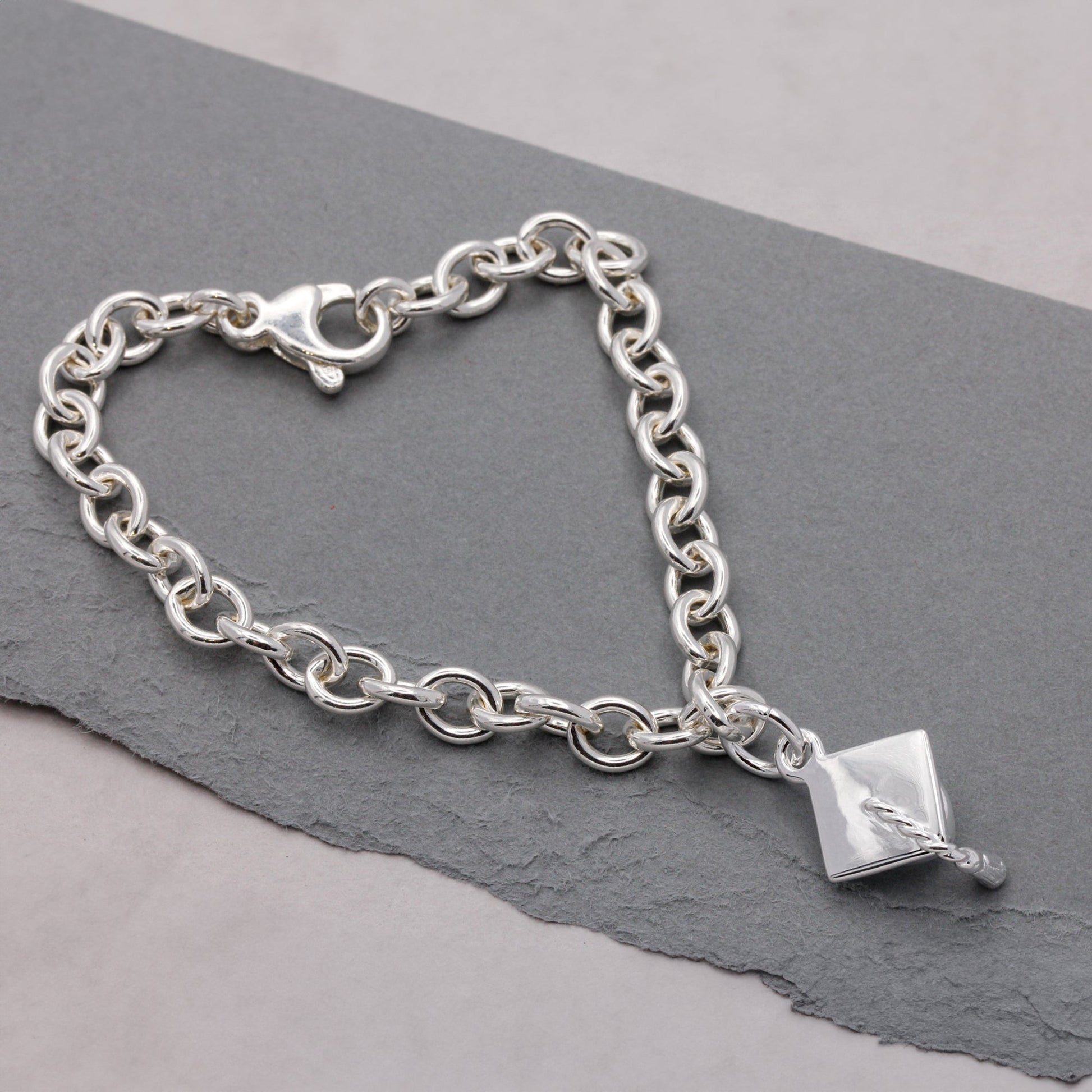 Silver charm bracelet with personalized mortar board charm by Scarlett Jewellery