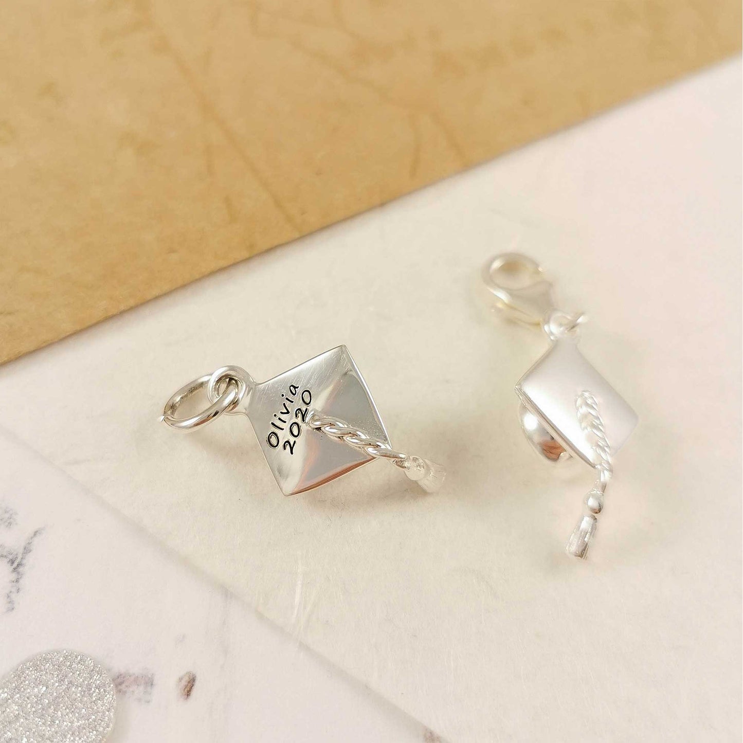 Silver charm bracelet with personalized mortar board charm by Scarlett Jewellery