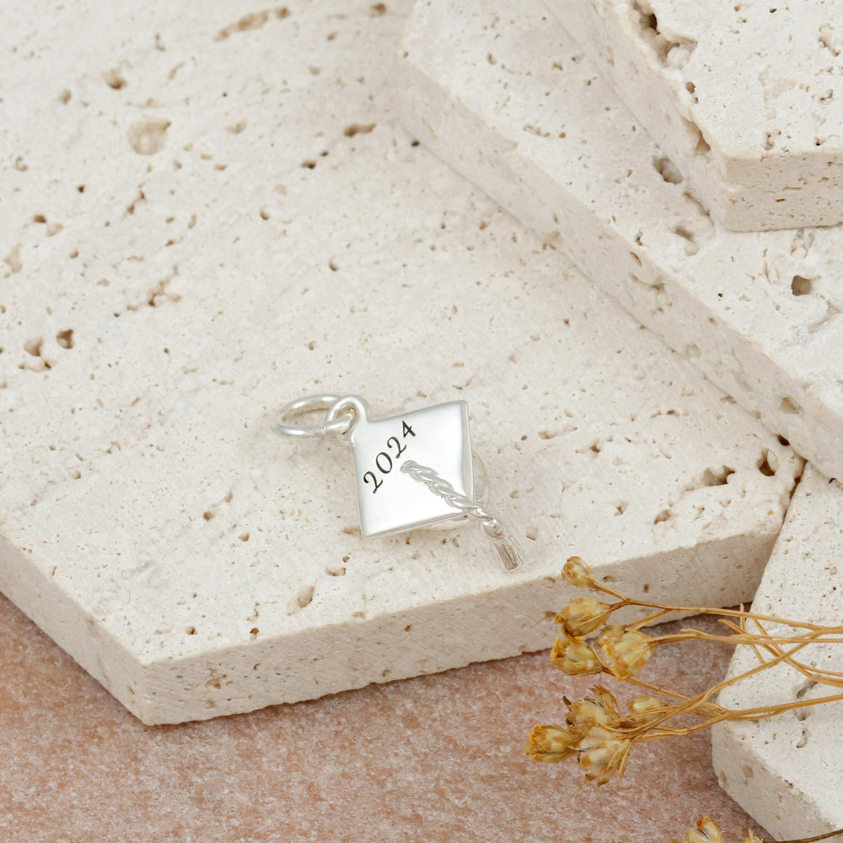 Silver charm bracelet with personalized mortar board charm by Scarlett Jewellery.