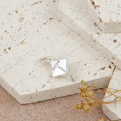 Silver charm bracelet with personalized mortar board charm by Scarlett Jewellery.