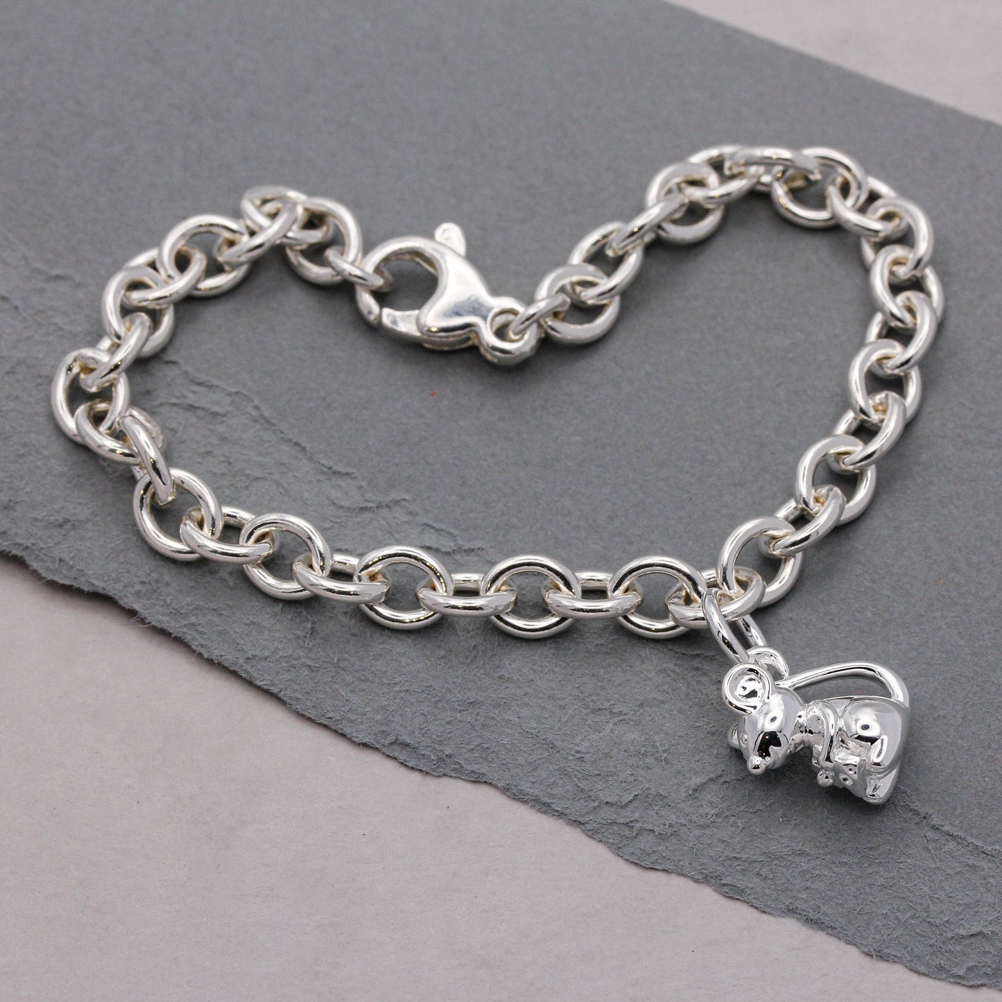 Silver mouse charm with detailed texture, displayed on a soft background, by Scarlett Jewellery.