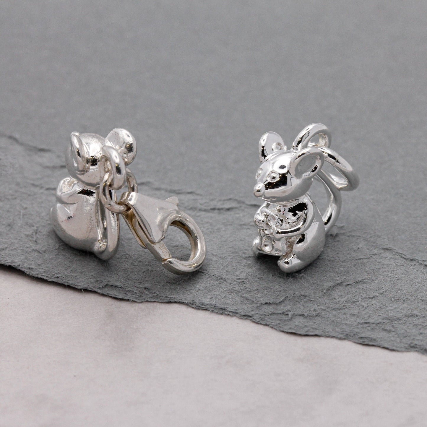 Silver mouse charm with detailed texture, displayed on a soft background, by Scarlett Jewellery.