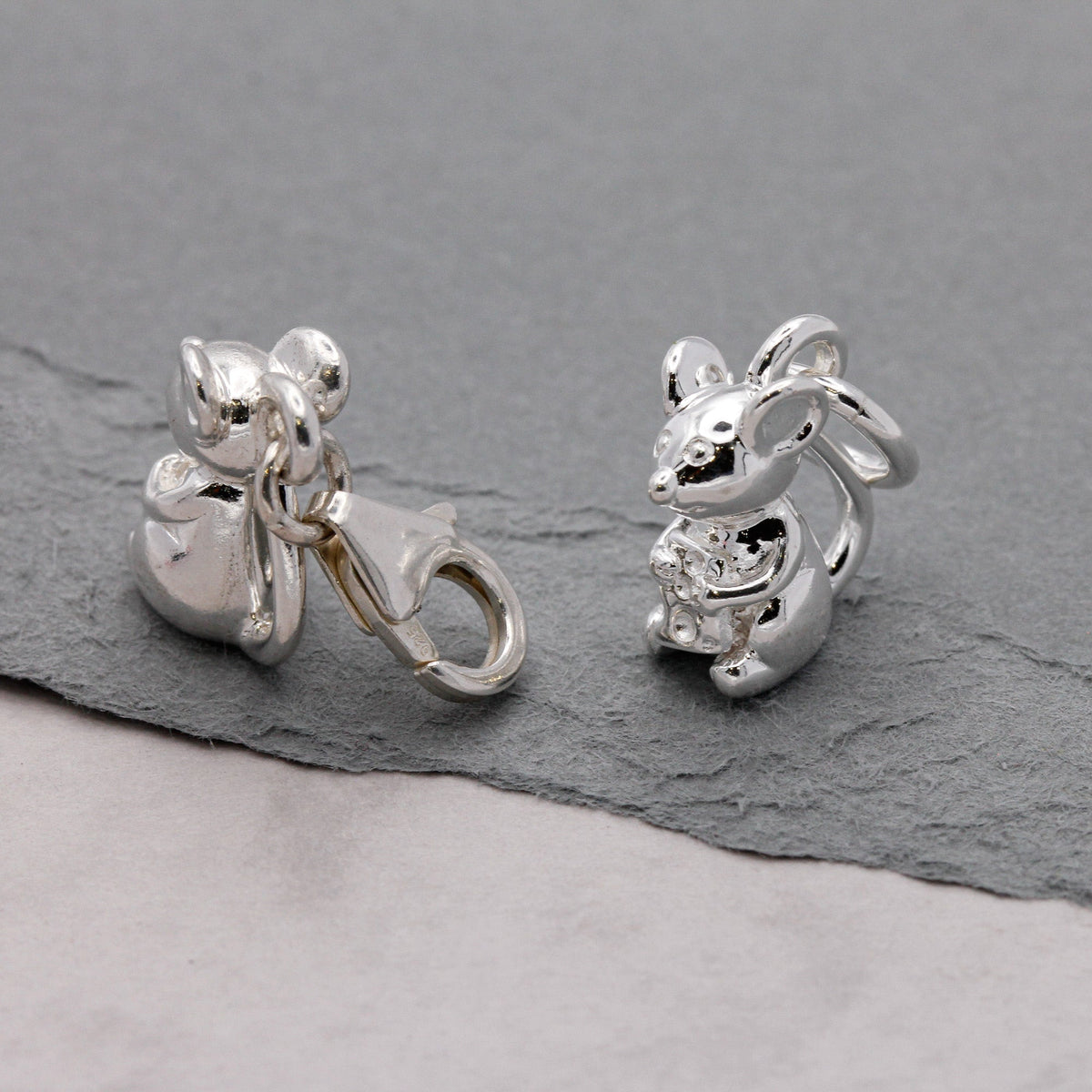Silver mouse charm with detailed texture, displayed on a soft background, by Scarlett Jewellery.