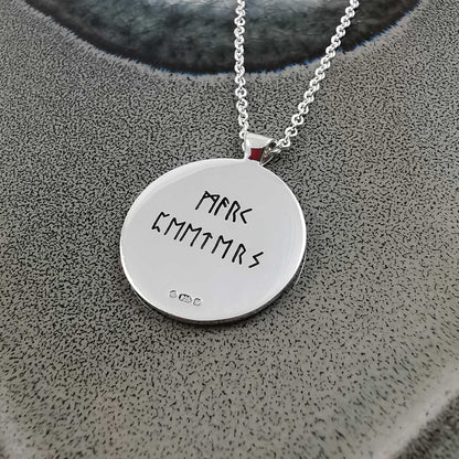 Silver Viking rune necklace with personalized engraving, shown close-up against a dark background by Scarlett Jewellery.