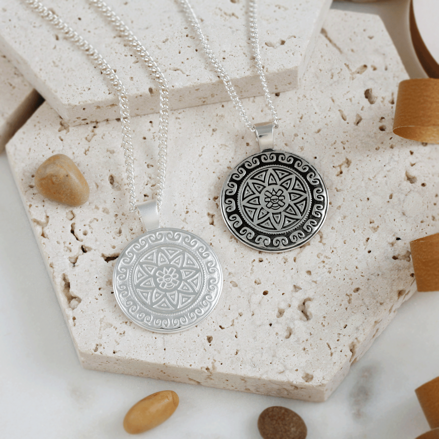 Silver necklace featuring an Aztec Ollin travel mandala design with personalized engraving by Scarlett Jewellery.