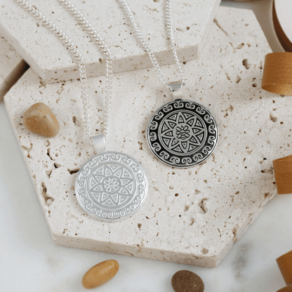 Silver necklace featuring an Aztec Ollin travel mandala design with personalized engraving by Scarlett Jewellery.