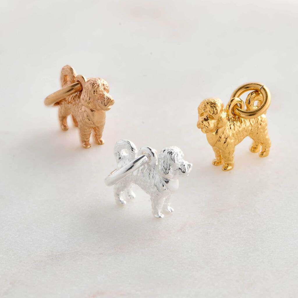 A silver cavapoo dog charm shaped like a small dog, detailed with a smooth finish and delicate features, by Scarlett Jeweller