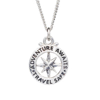 A large silver necklace featuring an outline compass and the name St Christopher, displayed against a dark background by Scar