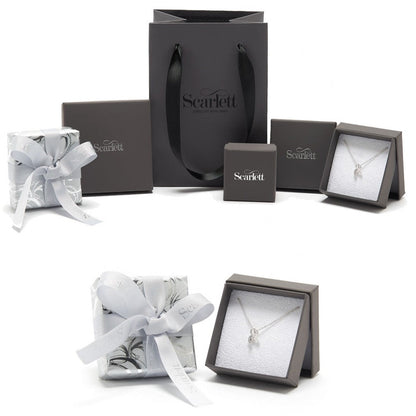 Silver paw print charm with personalized engraving on a jewelry display by Scarlett Jewellery.