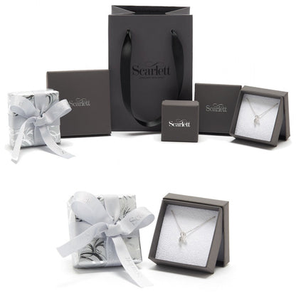 A silver charm bracelet featuring a delicate christening charm, styled on a white background by Scarlett Jewellery.
