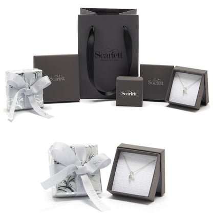 Silver forget-me-not flower charm with personalized engraving, displayed on a velvet background by Scarlett Jewellery.