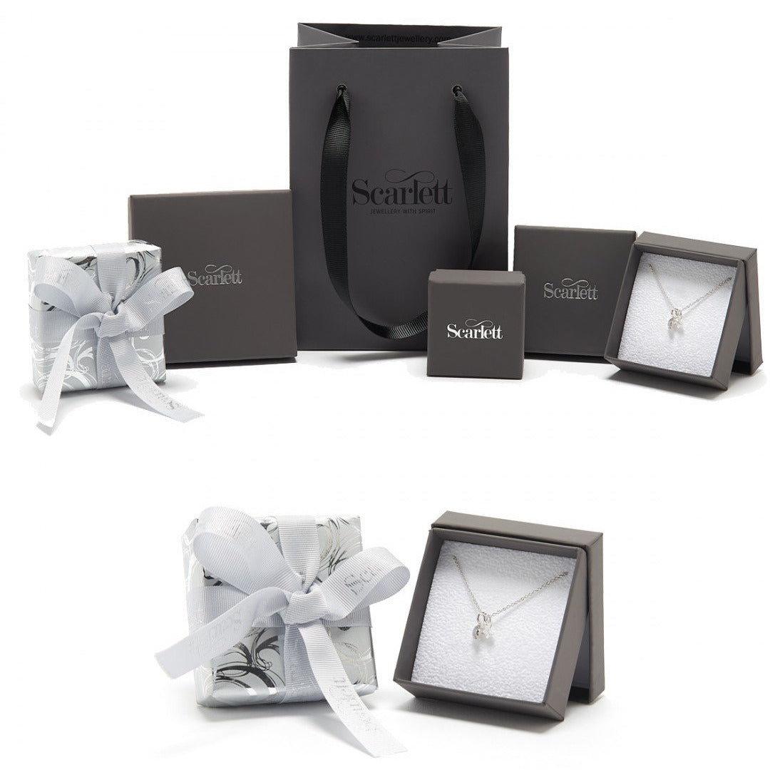 A silver Christmas tree charm with personalized engraving, displayed on a white background, by Scarlett Jewellery.