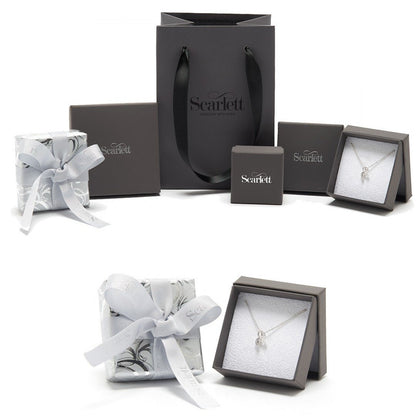 A silver Christmas tree charm with personalized engraving, displayed on a white background, by Scarlett Jewellery.