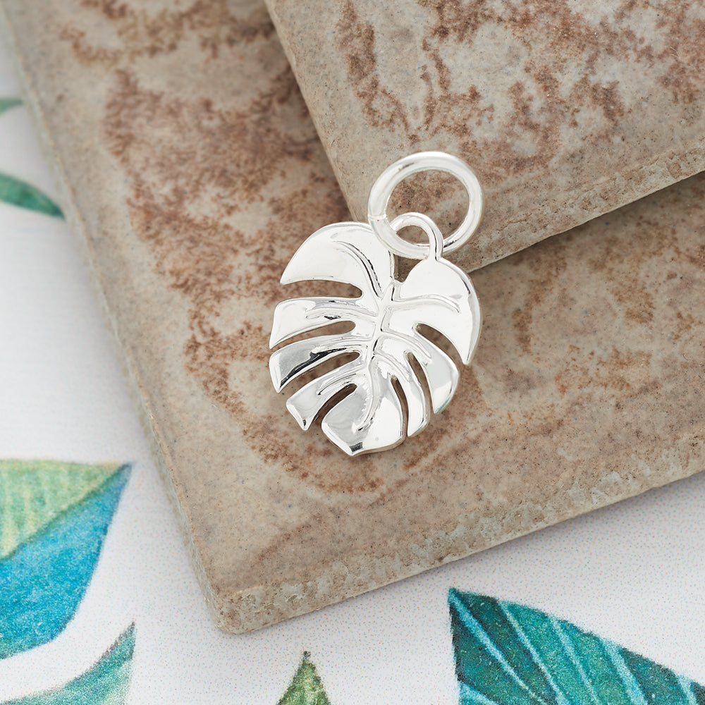 A silver monstera palm charm bracelet by Scarlett Jewellery with detailed leaf texture and elegant design