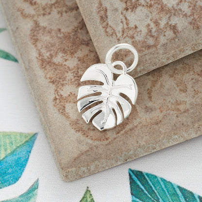 A silver monstera palm charm bracelet by Scarlett Jewellery with detailed leaf texture and elegant design