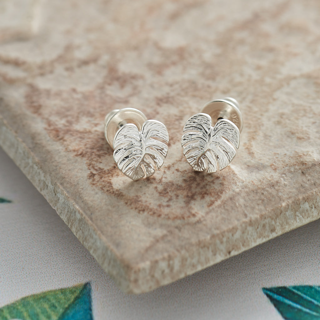 Silver stud earrings featuring a detailed monstera palm leaf design by Scarlett Jewellery.