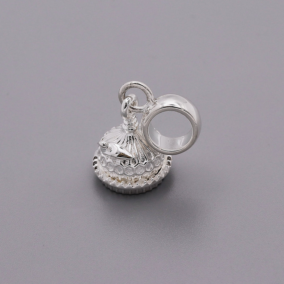 Silver charm shaped like the Brighton Pavilion, detailed and polished, displayed on a white background by Scarlett Jewellery.