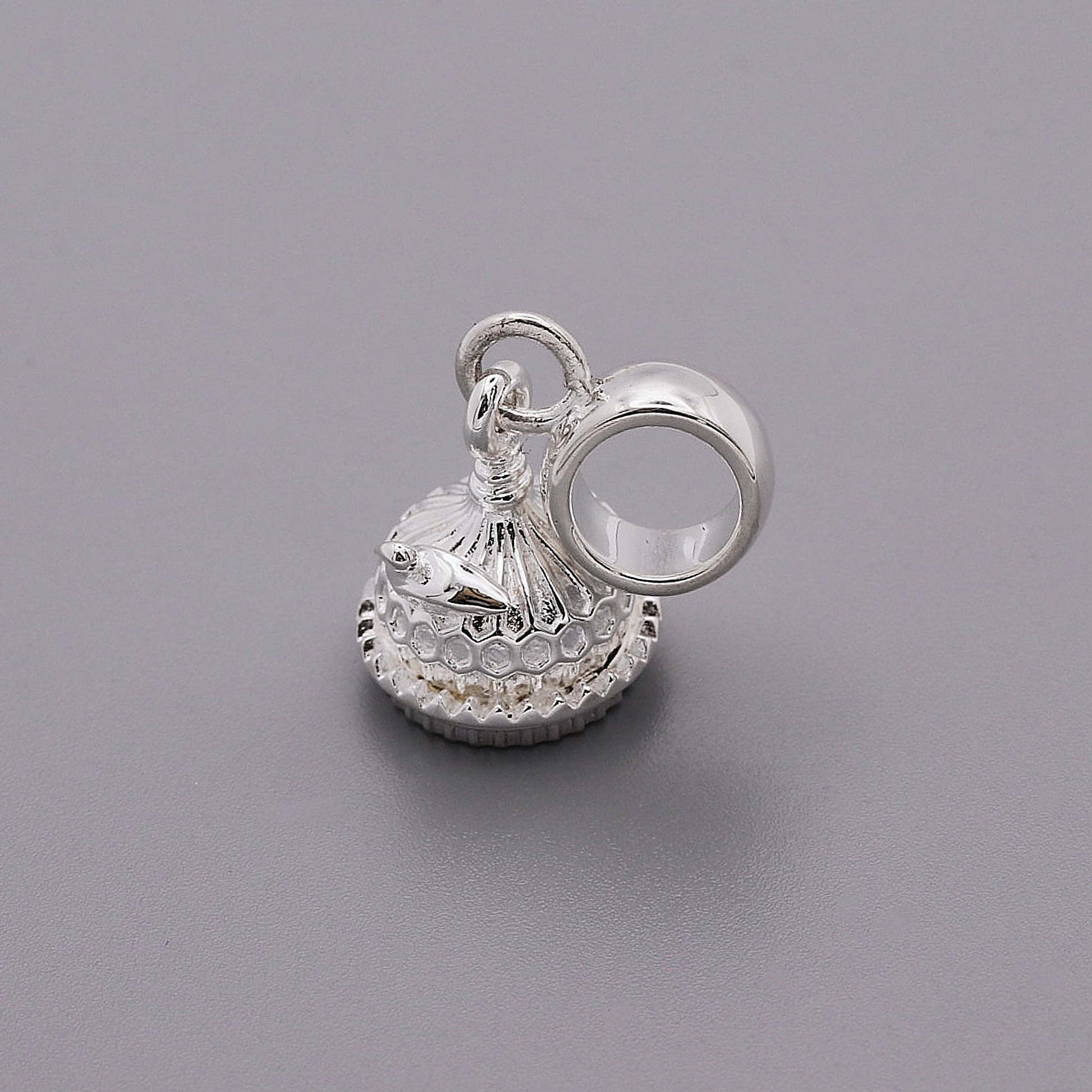 Silver charm shaped like the Brighton Pavilion, detailed and polished, displayed on a white background by Scarlett Jewellery.